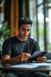 © พงศ์พล วันดี - Indian Man Focused on Reviewing Advertising Budgets in Modern Office Environment