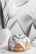 © Artem - Minimalist collage featuring a cinnamon roll with icing surrounded by abstract flowers and shapes