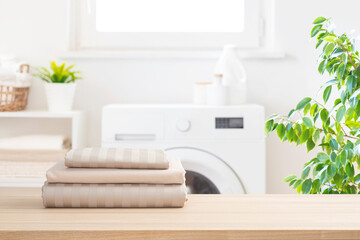 Wall Mural - Folded bedclothes in defocused rustic laundry room interior background