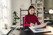 © Dino - Portrait of a woman working on a tablet computer in a modern office. Make an account analysis report. real estate investment information financial and tax system concepts