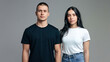 ©  Mohammad Xte - Casual Fashion Portrait of a Male in Black T-Shirt and a Female in White T-Shirt and Blue Jeans Standing Side by Side, Neutral Gray Background, Modern Stylish Look, High-Resolution Close-Up, Simple Cl