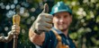 © schmidt - A smiling plumber in his work clothes gives a double thumbs up after installing a gleaming new kitchen faucet