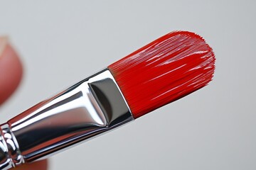 Aufkleber - Close-up view of a bright red paintbrush depicting fine bristles against a neutral background at an art studio