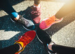 © peopleimages.com - People, shoes and feet with asphalt for fitness, sports fashion or training on road or street together above. Top view, sneakers or runners with circle in unity for huddle, team motivation or running