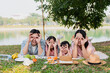 © Timeimage - Young Asian family having a picnic in the park on the weekend