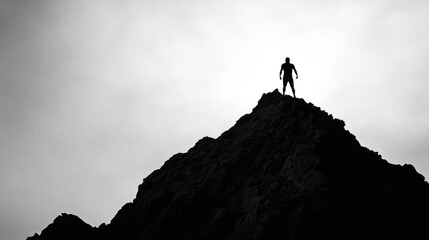 Poster - A striking silhouette of a man atop a mountain peak, silhouetted by a bright sky, symbolizing victory and the pursuit of personal goals.
