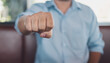 © Lahmz - A confident man showing a clenched fist in focus, symbolizing strength, determination, and unity. Perfect for concepts of motivation, empowerment, leadership, and personal success.