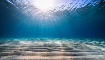Wall Mural - underwater view of rippling sandy ocean floor bathed in beautiful sunlight beams creating a serene a