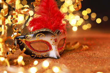 Wall Mural - Beautiful carnival mask on shiny color background, bokeh effect. Space for text