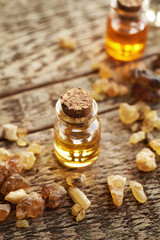 Wall Mural - A bottle of frankincense essential oil with frankincense resin