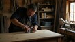 © ValencioL - A person carefully restoring an old wooden desk, sanding the surface with a hand tool in a cozy workshop, surrounded by tools and unfinished projects