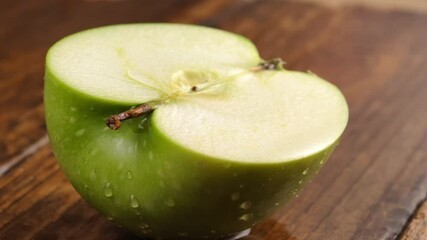 Wall Mural - Sliced ​​apple and water drops on wooden background