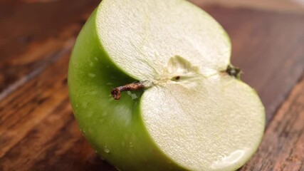 Wall Mural - Sliced ​​apple and water drops on wooden background