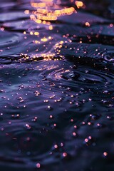 Poster - Glowing orange bokeh lights dancing on dark rippling water surface create magical evening atmosphere with reflections and water drops for nature backgrounds.