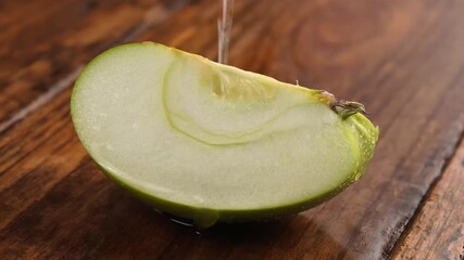 Wall Mural - Sliced ​​apple and water drops on wooden background