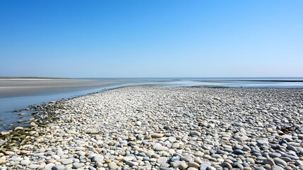 Serene Coastal Landscape with Smooth Pebbles and Clear Blue Sky