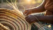 © Phurichai - Skilled Hands Weaving Traditional Colorful Basket Outdoors at Sunset