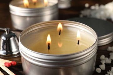 Wall Mural - Burning soy wax candles on table, closeup