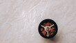 © Yelyzaveta - Roasted coffee beans inside black hand grinder top view on the white marble table. Space for text.