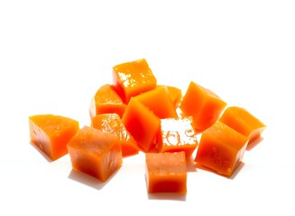 Wall Mural - an image of a pile of cubes of orange colored food, there are many pieces of orange cubes on a white surface