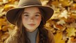 © The 2R Artificiality - teen girl wearing brown hat and cozy sweater in fall season portrait amidst golden autumn leaves outdoors