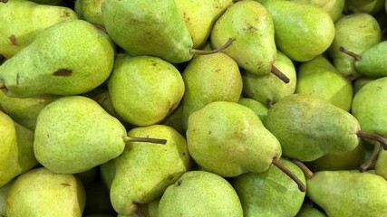 Wall Mural - Pears displayed on fruit stand, tracking shot on pears in crates in top view