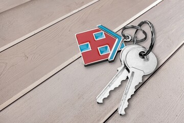 Sticker - Key with keychain house shaped on the table.