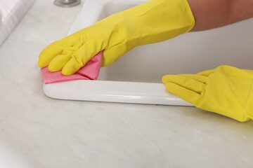 Wall Mural - Woman cleaning sink with rag in kitchen, closeup