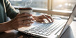 © Mr.Everything - Man typing on keyboard in office with hands on laptop, close-up view of fingers working on computer