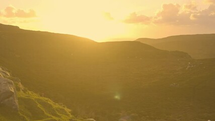 Wall Mural - Horn Head Donegal Ireland - A stunning sunset brilliantly illuminating the lush green hills, creating an incredibly serene and beautiful landscape