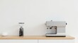 © Sumrit - Sleek Espresso Machine and Grinder on Light Wood Countertop Against a White Wall, Ready for Brewing a Delicious Cup of Coffee