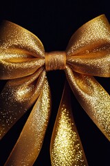 Wall Mural - A shiny gold bow sitting on a black background