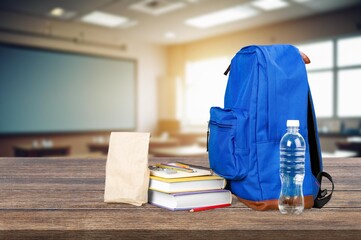 Canvas Print - Colored school backpack on desk in classroom