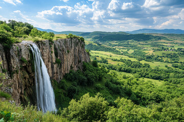 Poster - Beautiful waterfall cascading from a steep rocky cliff surrounded by lush green trees and hills, offering a stunning panoramic view of nature and serene outdoor landscapes.