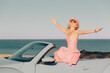 © Sunny studio - Happy young woman travel by car by the sea