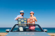 © Sunny studio - Happy couple in love travel by car by the sea