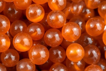 Poster - Polished amber glass beads display a stunning array of rich colors and smooth textures, enhanced by gentle reflections that create a captivating visual effect
