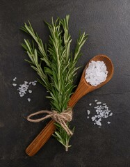 Wall Mural - Fresh rosemary and coarse sea salt on dark background. Rustic kitchen still life.