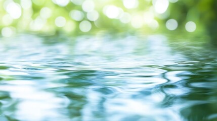 Poster - Soft ripples spreading across calm water surface, blurred green background creating peaceful, meditative bokeh effect reflecting natural tranquility