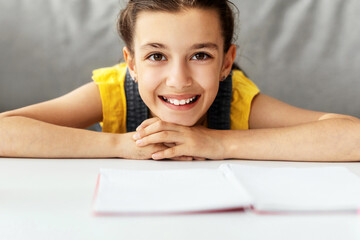 Aufkleber - Closeup Portrait Of Cute Teenage Girl Smiling And Looking At Camera, Happy Young Lady Posing Sitting At Desk, Doing Homework, Selective Focus, Blurred Background, Banner, Free Copy Space