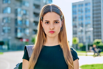 Wall Mural - Headshot portrait serious student teenage girl with backpack outdoor