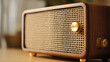 © SashaMagic - Vintage wooden radio with gold knobs on a table.