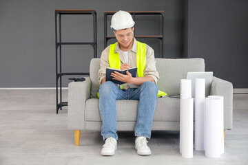 Wall Mural - male contractor with notebook writing on sofa in room