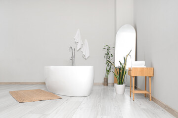 Wall Mural - Interior of light room with bathtub, mirror and plants