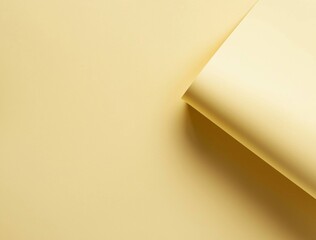 Poster - Minimalist composition featuring a curved sheet of pastel yellow paper casting subtle shadows on a smooth surface, creating an abstract and elegant backdrop