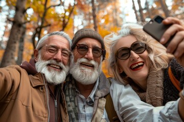 Wall Mural - Senior couple taking selfie with smartphone in autumn park. Elderly people and lifestyle concept.