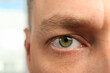 © New Africa - Closeup view of man with green eyes