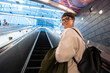 © Alvaro Lavin/Stocksy - Businesswoman going up escalator in New York City subway station