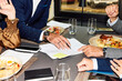 © Boris Jovanovic/Stocksy - Business contracts in the restaurant