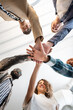 © Alvaro Lavin/Stocksy - Coworkers joining hands, fostering teamwork and collaboration